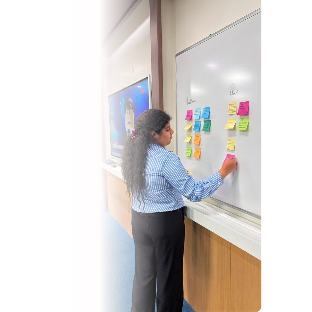 Program facilitator writing session notes on a whiteboard